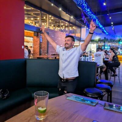 Man celebrating while playing Dartsee interactive darts at The Foundry Hotel