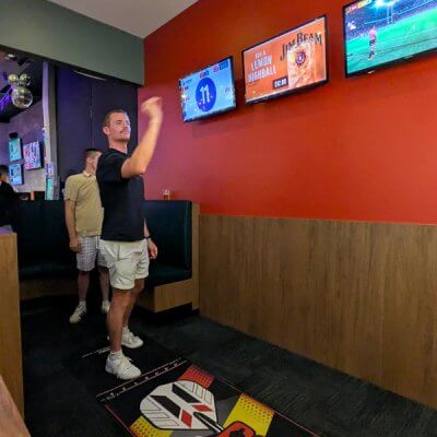 Man celebrating while playing Dartsee interactive darts at The Foundry Hotel