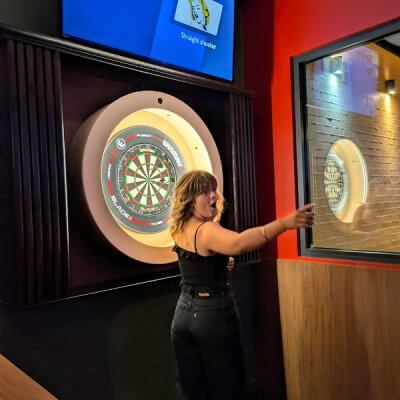 Women celebrating while playing Dartsee interactive darts at The Foundry Hotel